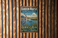 A vintage metal sign for Bandon Marsh National Wildlife Refuge in Oregon, featuring a large blue heron and a serene landscape.
