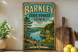 A vintage-style sign for the state forest in Iowa, featuring a scenic landscape with a lake, mountains, and pine trees.
