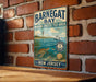 A vintage metal sign for BarnEGAT Bay, a marine protected area in New Jersey, featuring a lighthouse and marine life.