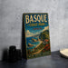 A vintage-style metal sign for Basque Coast Park in Spain, featuring a scenic coastal landscape with cliffs, houses, and a beach.