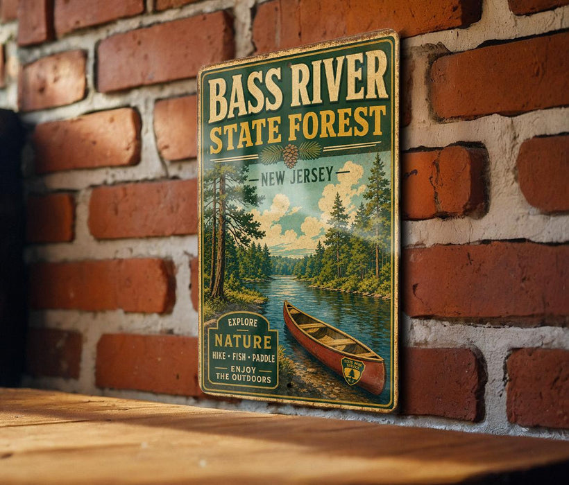A vintage-style metal sign for the Bass River State Forest in New Jersey, featuring a canoe and a scenic landscape.