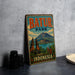 A vintage-style metal sign for Batur Park in Indonesia, featuring a mountain landscape and temple-like structures.