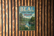 A vintage metal sign for the Beal State Forest in Missouri, featuring a scenic image of a forest and a river.