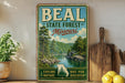 A vintage-style metal sign for the Beal State Forest in Missouri, featuring a scenic landscape with a river and trees.