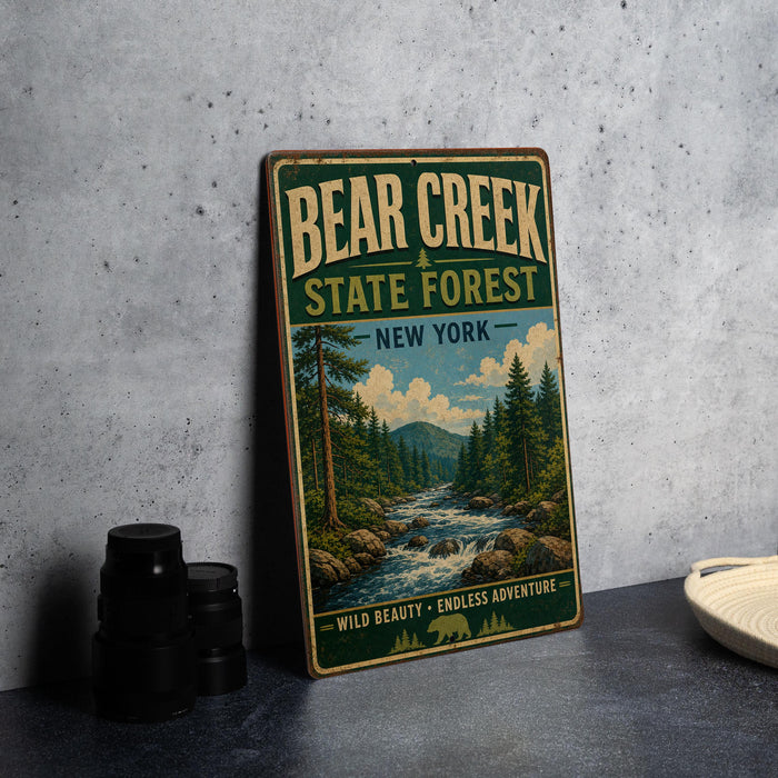 A vintage-style metal sign for Bear Creek State Forest in New York, featuring a scenic illustration of a forest and a river.