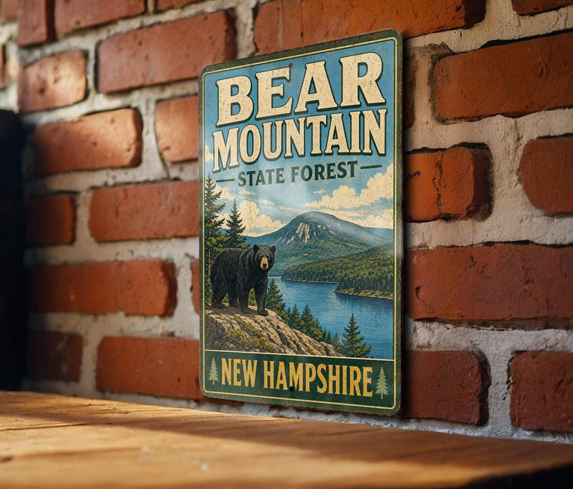 A vintage-style metal sign with the text "BEAR MOUNTAIN STATE FOREST" and "NEW HAMPSHIRE" is displayed on a brick wall.