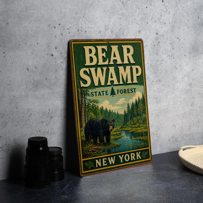 A vintage metal sign for Bear Swamp State Forest in New York, featuring a black bear in a forest setting.