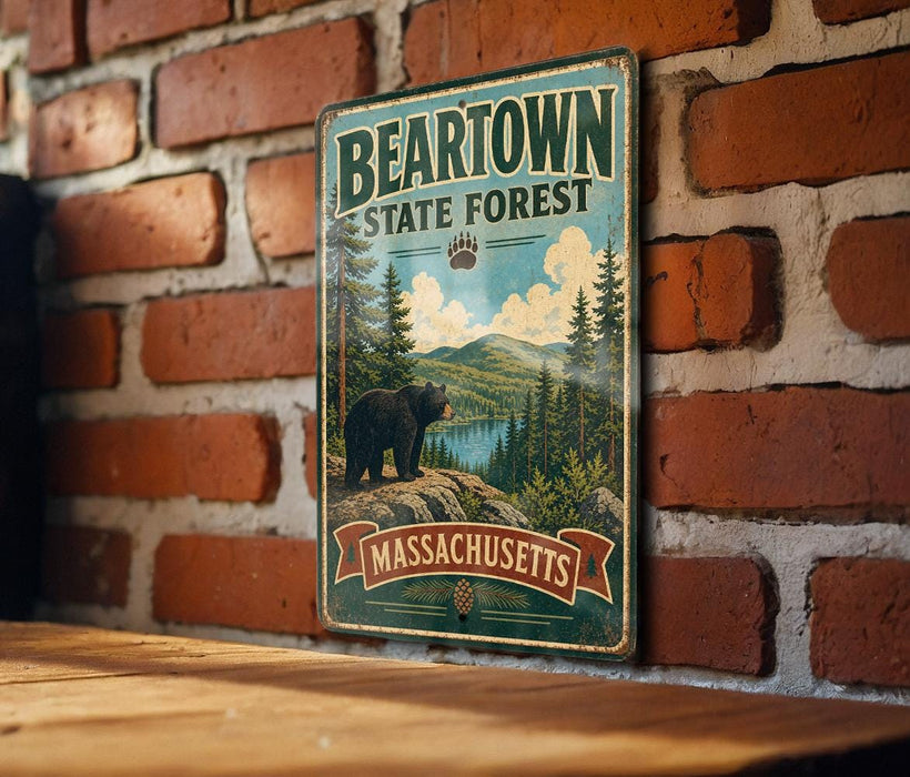 A vintage metal sign for the Beartown State Forest in Massachusetts, featuring a bear and a scenic landscape.