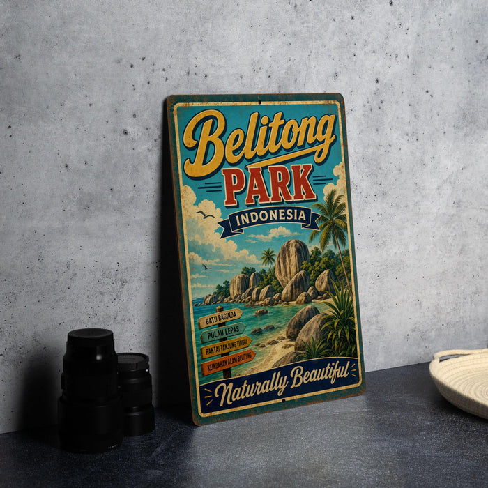 A vintage-style metal sign for Belitong Park, Indonesia, featuring a tropical beach scene with palm trees and rocks.