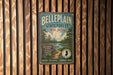 A vintage metal sign for Bellplain State Forest in New Jersey, featuring a scenic image of pine trees and a river.