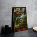 A vintage-style metal sign for Berkeley Plantation, a historic plantation in Virginia, featuring an illustration of a house surrounded by trees and flowers.