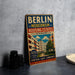 A vintage metal sign advertising modern housing in Berlin, Germany, with a colorful illustration of an apartment building and a tree.