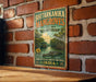 A vintage-style sign for the Bhtarkanika Mangroves, a nature reserve in Odisha, India, is displayed on a brick wall.