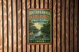 A vintage-style metal sign for the Bhtarkanika Mangroves, a nature reserve in Odisha, India, is displayed on a wooden wall.