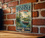 A vintage-style metal sign with the text "Biesbach Nederland" hanging on a brick wall.