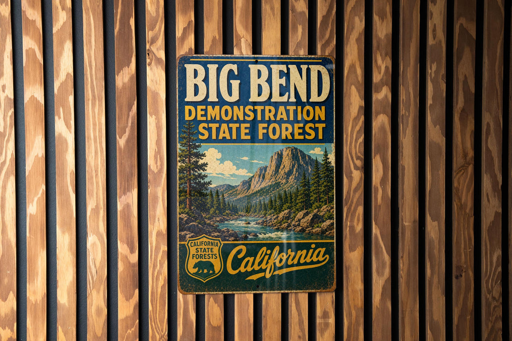 A vintage metal sign for Big Bend, the demonstration state forest in California, is displayed on a wooden wall.