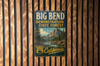 A vintage metal sign for Big Bend, the demonstration state forest in California, is displayed on a wooden wall.