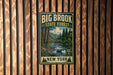 A vintage-style metal sign for the Big Brook State Forest in New York, featuring a scenic illustration of a forest and a river.