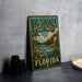 A vintage-style metal sign for Big Shoals State Forest in Florida, featuring an illustration of a forest landscape with a river and pine trees.