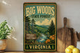 A vintage-style sign for the Big Woods State Forest in Virginia, featuring a scenic illustration of a forest landscape with a river and mountains.