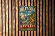 A metal sign for the Billy Goat Trail in Maryland, featuring a mountain landscape with a goat.