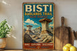 A vintage-style poster advertising the Bisti Badlands Trail in New Mexico, featuring a scenic illustration of the trail and rock formations.