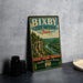 A vintage-style metal sign for Bixby State Preserve, Iowa, featuring a scenic landscape with a river and forest.