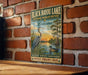 A vintage-style sign for Black Bayou Lake, Louisiana, featuring a heron and a duck in a natural setting.