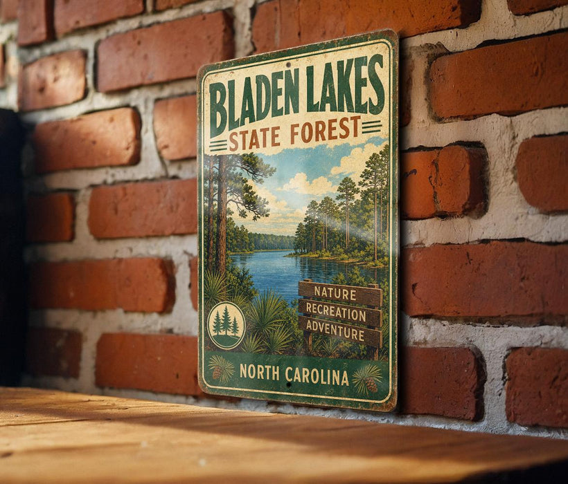 A vintage metal sign for Bladen Lakes State Forest, featuring a scenic image of the lake surrounded by pine trees and mountains.