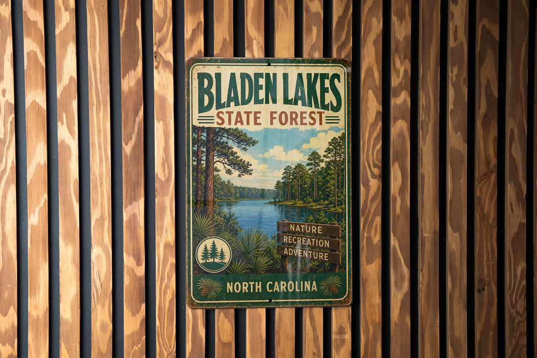 A vintage metal sign for Bladen Lakes State Forest in North Carolina, featuring a scenic image of the lake surrounded by pine trees.