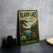 A vintage-style metal sign for Bladen Lakes State Forest in North Carolina, featuring a scenic illustration of the lake surrounded by pine trees and a blue sky.