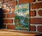 A vintage-style metal sign for Blanchard State Forest in Washington, featuring a scenic mountain landscape and inviting visitors to "Welcome to your outdoor adventure".