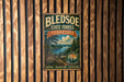 A vintage-style metal sign for Bledsoe State Forest in Tennessee, featuring a scenic landscape with a lake and mountains.