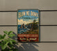 A vintage-style sign for "Blow Me Down" in thePROVINCIAL PARK of New Brunswick, Canada, advertising "Newfoundland & Labrador" and "Adventure Awaits".