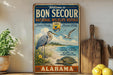 a vintage-style sign for the Bon Secour National Wildlife Refuge in Alabama, with illustrations of birds and a turtle.