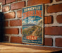 A vintage-style metal sign for the Bonneville Shoreline Trail in Utah, featuring a scenic mountain landscape and a winding trail.