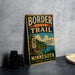 A vintage metal sign for the Border Route Trail in Minnesota, featuring a scenic illustration of a forest and a lake.
