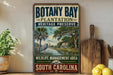 A vintage-style metal sign for Botany Bay Plantation, Heritage Preserve, and Wildlife Management Area in South Carolina, featuring a scenic illustration of a bird and palm trees.