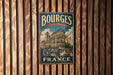 A vintage metal sign with the text "BOURGES CATHEDRAL FRANCE" is displayed on a wooden wall.