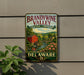 A vintage-style metal sign for Brandywine Valley, featuring a scenic landscape with a red brick building, a mill, and a river with a bridge.