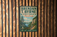 A vintage metal sign for Brendan T. Byrne State Forest in New Jersey, featuring a scenic illustration of a forest and a lake.