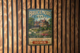 A vintage-style metal sign for the Brucemore Estate in Iowa, featuring a large illustration of a historic building surrounded by trees and flowers.