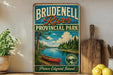 A vintage-style sign for Brudenzell River Provincial Park, featuring a canoe on a river surrounded by trees and mountains.