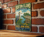 A vintage metal sign for Burton Island Nature Preserve in Delaware, featuring a heron and a scenic landscape.