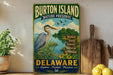 A vintage metal sign for Burton Island Nature Preserve in Delaware, featuring a blue heron and a scenic landscape.