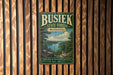 A vintage-style metal sign for Busiak State Forest in Missouri, featuring a scenic landscape with a lake and mountains.