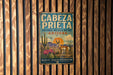 a vintage-style metal sign with a desert landscape and wildlife, mounted on a wooden wall.