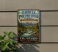 A vintage metal sign for the Cache la Poudre River National Heritage Area in Colorado, featuring a scenic mountain landscape with a flowing river.