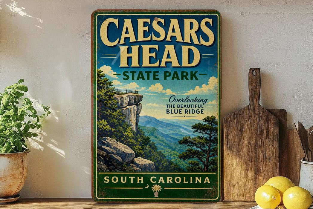 a vintage-style sign for Caesars Head State Park in South Carolina, with a scenic mountain landscape and a wooden cutting board on a shelf.