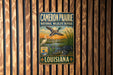 A vintage metal sign for the Cameron Prairie National Wildlife Refuge in Louisiana, featuring an illustration of ducks and alligators in a grassy landscape.